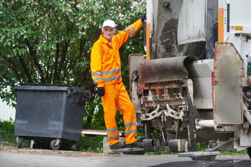 Insured rubbish removal vehicle at a business site