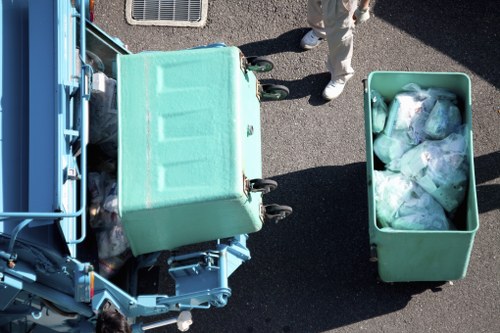 Separated recycling containers for paper, plastic and glass in a commercial yard
