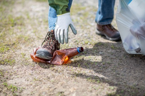 Workers using PPE while handling commercial rubbish containers