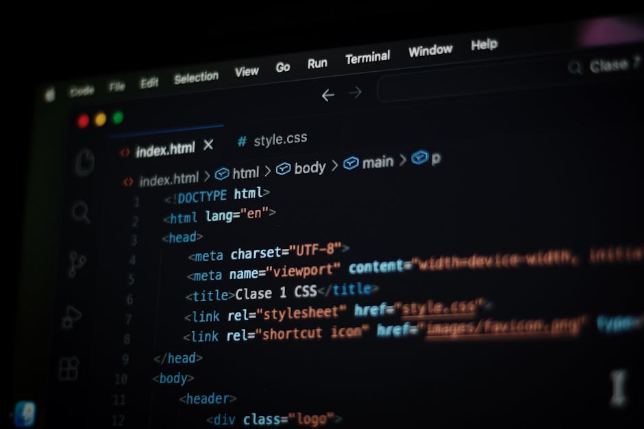 A close-up view of a computer screen displaying lines of colorful programming code with various syntax elements in red, green, blue, and yellow. The text appears slightly blurred, emphasizing the use 